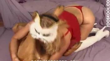 Masked female fucked by brown dog in doggy style
