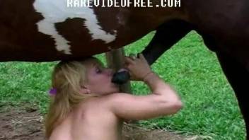 Blonde slut struggles with a huge horse penis in her tiny holes