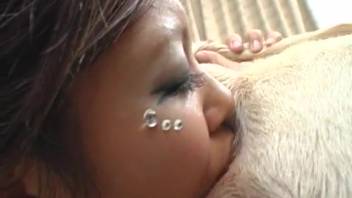 Asian babe with a sweet piercing sucks off two canine cocks