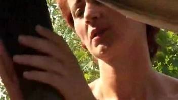 Fiery-haired babe gives oral to a massively hung stallion after intercourse