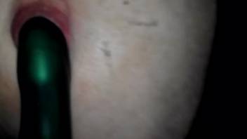 Narrow beast's rear hole penetrated by an emerald dildo