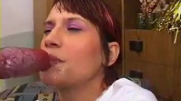 Ginger-haired hottie opts to inspect a canine's crimson dick